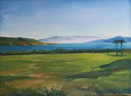 Serene Countryside Under Distant Mountains